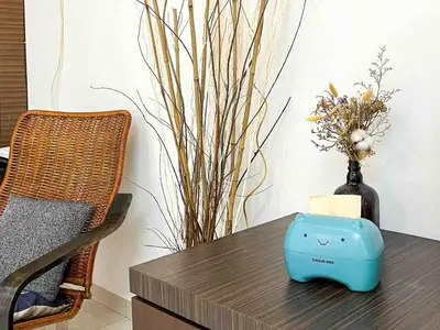 a table with a blue device on top of it with a vase at \u60a6\u5ba2YK Homestay 5mins to IconCity in Bukit Mertajam