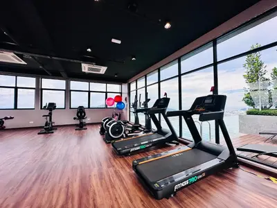 a gym with several treadmills and elliptical machines at Iconic Regency Seaview Homestay with Rooftop Pool in Bayan Lepas