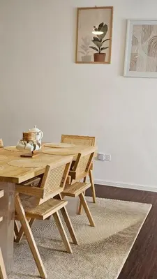 a dining room with a wooden table and chairs at Kea Farm Stay in Brinchang