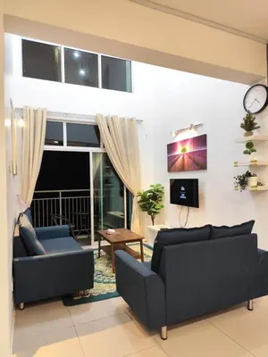 a living room with two couches and a tv at Bukit Urbane Night Market CH in Brinchang