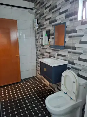 a bathroom with a toilet and a sink at Family Homestay Bidor in Gua Sai