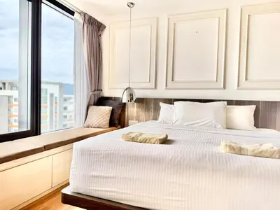 a bedroom with two beds and a large window at Tropicana 218 Macalister #LuxuryFrenchVintage #InfinityPool #Studio2pax #Quality well maintained #Private host in George Town