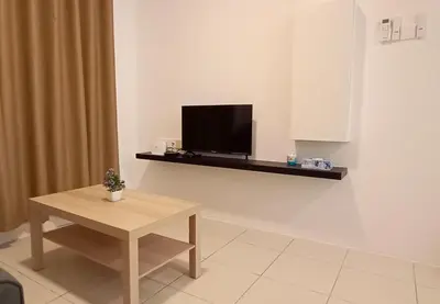 a living room with a table and a tv on a wall at Ipoh Homestay at Anderson - 2 Room 2 Bathroom -Maximum 6 pax --Self Check In-- in Ipoh