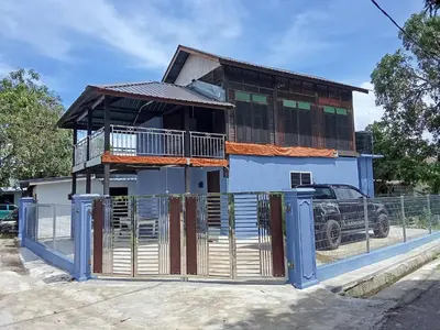 a house with a gate in front of it at Teratak Taha in Kepala Batas