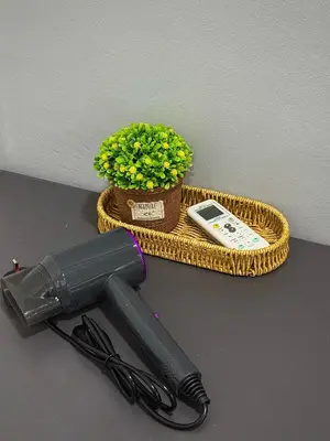 a hair dryer sitting next to a basket with a plant at Modern & Cozy Home Stay in Kampar