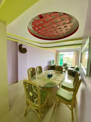 a dining room with a table and chairs at SK Holiday Apartment in Tanah Rata