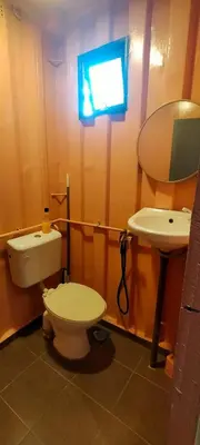 a bathroom with a toilet and a sink at Casa Studio Roomstay Sekinchan in Sekincan