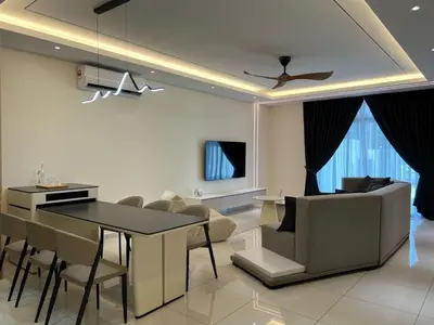 a kitchen and living room with a table and chairs at Karaoke Cozy Landed Home at Sutera n Paradign for 10pax in Gua Sai