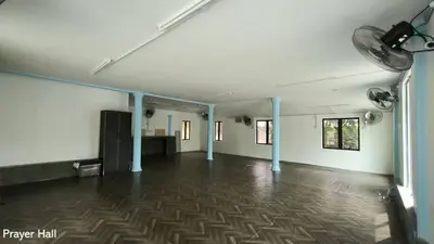 a large empty room with blue poles and a floor at Ulu River Lodge, Riverbug Perak in Gopeng