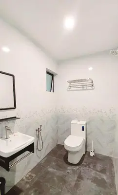 a bathroom with a toilet and a sink at The Minimalist Stay Station 18 in Ipoh
