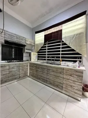 a kitchen with a sink and a stove top oven at Pa&Ma HomeStay Kulim III 3R2B FullyAircond in Gua Sai