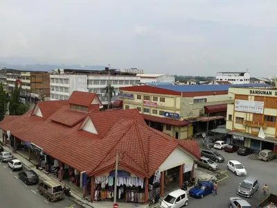 a building with a red roof in a city at HotelMalaya in Taiping