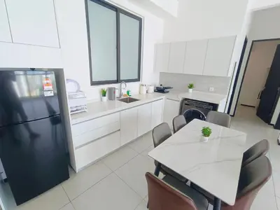 a kitchen with a refrigerator and a table with chairs at Infinity Pool, Urban Suites, Georgetown, 2 Car Parks by Star Home in George Town