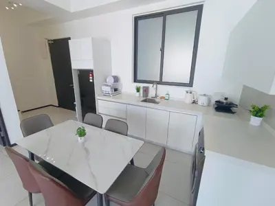 a kitchen with a white table and chairs at Infinity Pool, Urban Suites, Georgetown, 2 Car Parks by Star Home in George Town