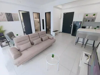 a living room with a couch and a table at Infinity Pool, Urban Suites, Georgetown, 2 Car Parks by Star Home in George Town