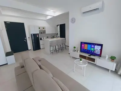 a living room with a couch and a tv at Infinity Pool, Urban Suites, Georgetown, 2 Car Parks by Star Home in George Town