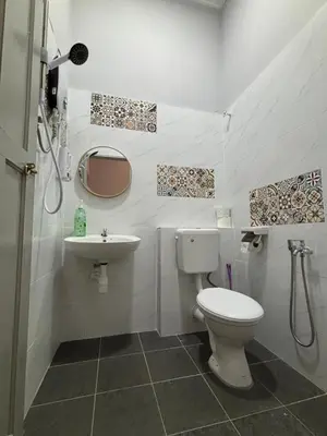 a bathroom with a toilet and a sink at Bercham Landed CornerLot 6BR with Karaoke Set & BBQ in Ipoh