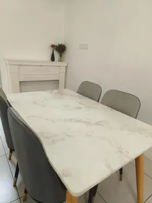 a white table with four chairs around it at Meritus in Perai