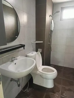 a bathroom with a white toilet and a sink at Meritus in Perai