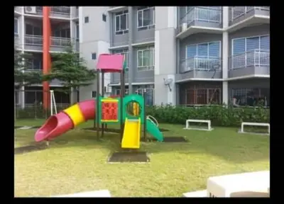a playground in front of a large building at DhiyaAdraHomestay in Chemor