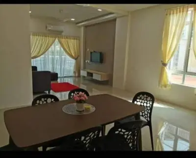 a dining table and chairs in a living room at DhiyaAdraHomestay in Chemor
