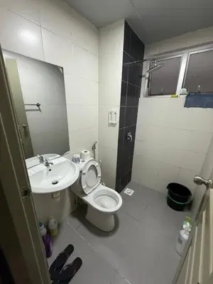 a bathroom with a toilet and a sink at AYAAN Flora Quintet Apartment & Fifa Home 4 with Free Parking in Tanah Rata