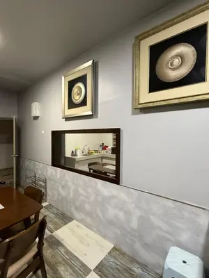 a dining room with a large mirror on the wall at AYAAN Flora Quintet Apartment & Fifa Home 4 with Free Parking in Tanah Rata
