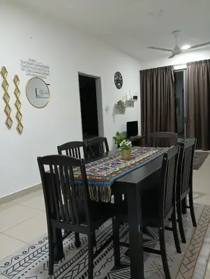 a dining room with a black table and chairs at Ereens homestay 3 Palas horizon in Cameron Highlands
