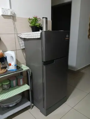 a small refrigerator in a kitchen with a shelf at Ereens homestay 3 Palas horizon in Cameron Highlands