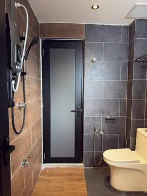 a bathroom with a toilet and a shower at LYL Ipoh Garden Private Pool Villa-18pax 5BR in Ipoh