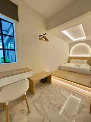 a bedroom with a bed and a desk and a window at LYL Ipoh Garden Private Pool Villa-18pax 5BR in Ipoh