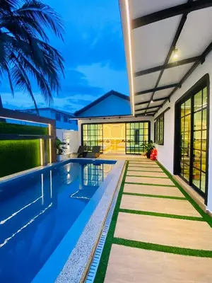 a swimming pool in the backyard of a house at LYL Ipoh Garden Private Pool Villa-18pax 5BR in Ipoh