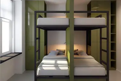 three bunk beds in a room with a window at Dynamic capsule in Gua Sai