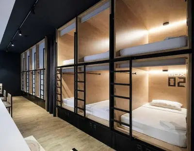 a group of bunk beds in a room at Dynamic capsule in Gua Sai