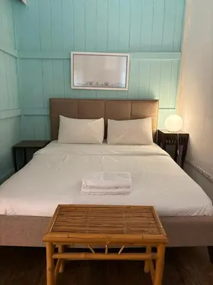 a bedroom with a bed with a wooden table on it at Ah Tong Residence - 3 mins to Kimberley Night Market in George Town
