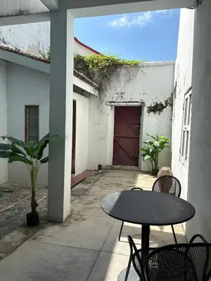 a patio with a table and chairs and a garage at Ah Tong Residence - 3 mins to Kimberley Night Market in George Town