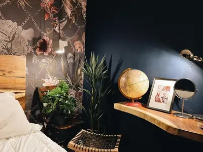 a bedroom with a desk with a globe and plants at Very Hotel in George Town