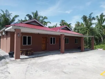a small house with a red roof at Dhania Homestay in Gua Sai