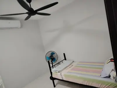 a room with a bed with a ceiling fan at Happy Home in Kuala Kubu Baharu