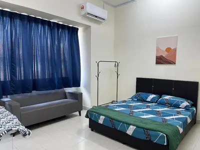 a bedroom with a bed and a couch in it at TemuHomestay in Kamunting
