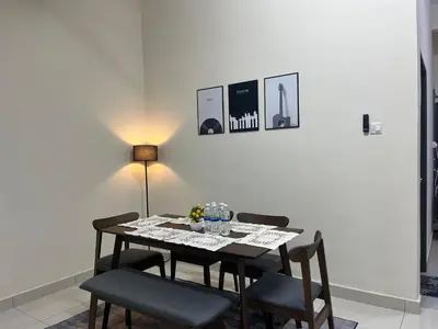 a dining room with a table with chairs and a lamp at TemuHomestay in Kamunting