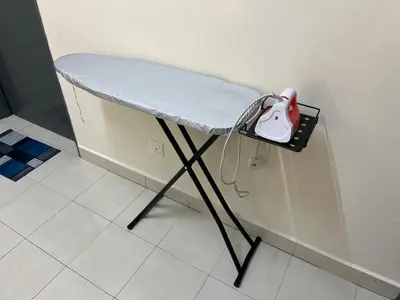 a counter with a chair and a pink object on it at TemuHomestay in Kamunting
