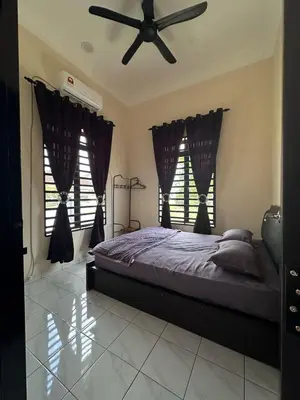 a bedroom with a bed and a ceiling fan at Yash Cottage Taiping Homestay in Taiping