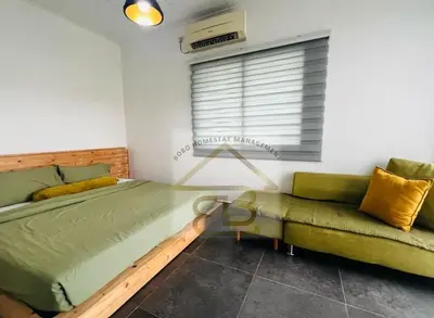 a bedroom with a bed and a couch and a window at 188 Private Pool Mansion Ipoh KTV BBQ 30Pax in Ipoh