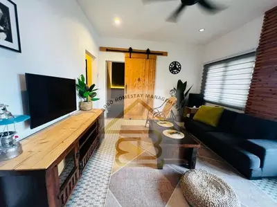 a living room with a couch and a flat screen tv at 188 Private Pool Mansion Ipoh KTV BBQ 30Pax in Ipoh