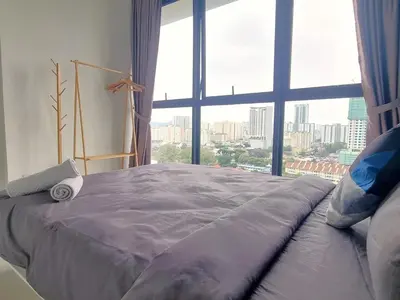 a large bed in a room with a large window at Urban Suites, 4 Plus 2 Pax, 2 Bedrooms Apartment in Jelutong