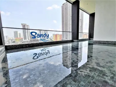 a balcony with a swimming pool in a building at Urban Suites, 4 Plus 2 Pax, 2 Bedrooms Apartment in Jelutong