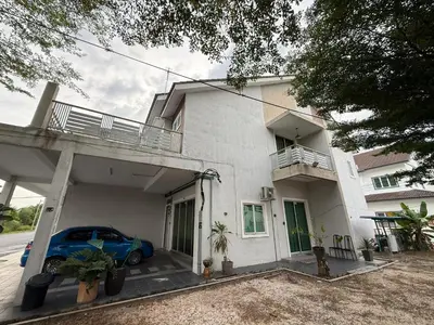 a car parked in front of a white house at Botani Lodge in Ipoh