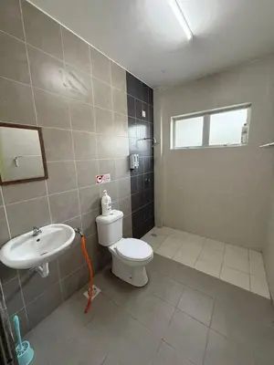 a bathroom with a toilet and a sink at Botani Lodge in Ipoh