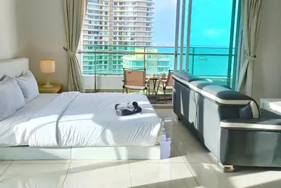 a hotel room with a bed and a large window at Gurney Drive Mansion One by RL SUITE in George Town